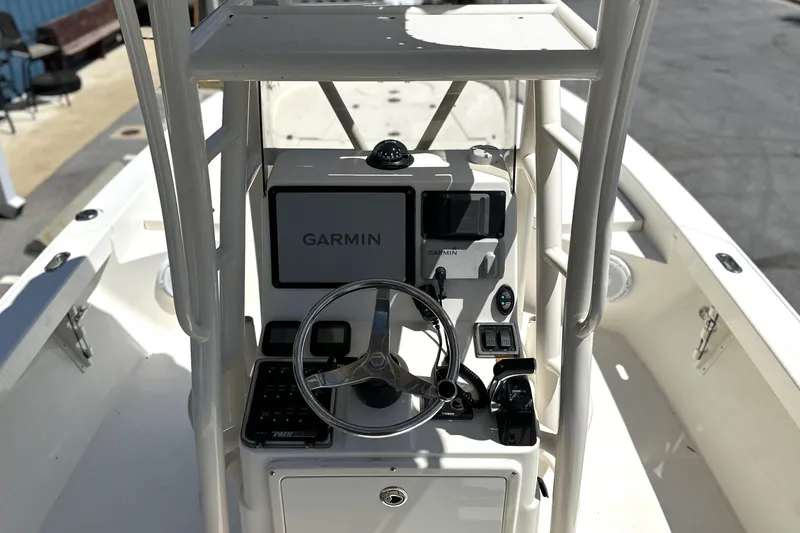 Slide: The Image of 2014 Pathfinder 2600 HPS boat console with Garmin navigation system and steering wheel. - 6