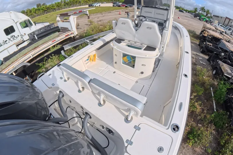 Slide: The Image of 2023 ShearWater 270 Carolina Flare boat with dual engines and modern cockpit design. - 11