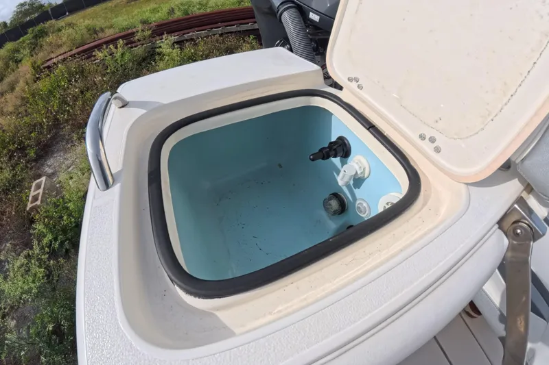 Slide: The Image of Open storage compartment on 2023 ShearWater 270 Carolina Flare boat, showing interior details. - 14