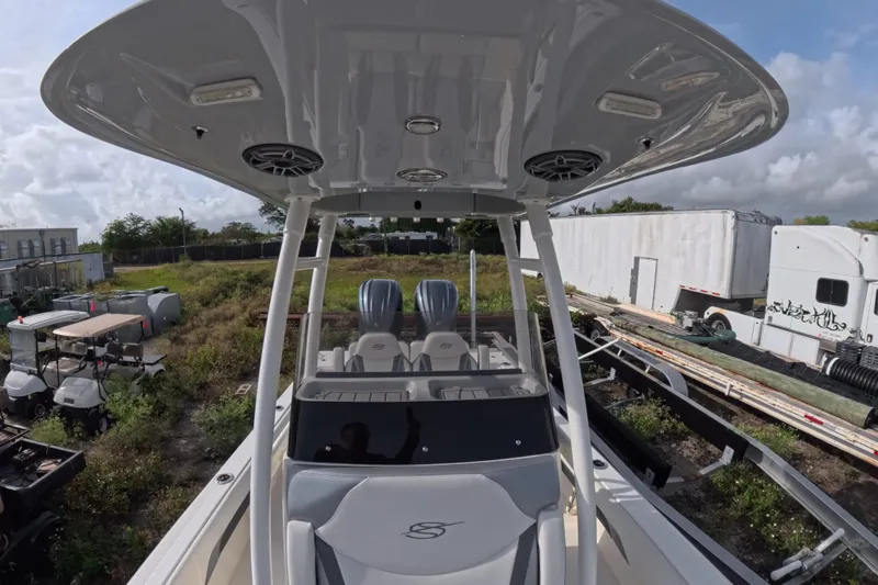 Slide: The Image of 2023 ShearWater 270 Carolina Flare boat with dual engines, parked outdoors. - 21