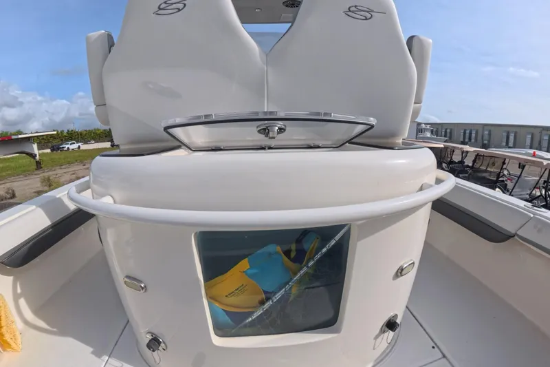Slide: The Image of 2023 ShearWater 270 Carolina Flare boat interior with seating and storage compartment. - 25