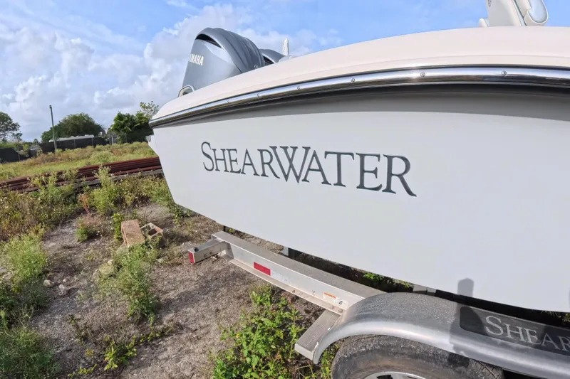 Slide: The Image of 2023 ShearWater 270 Carolina Flare boat on trailer, side view with logo. - 3