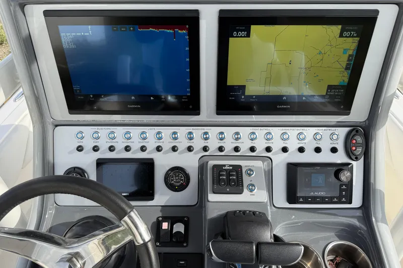 Slide: The Image of 2023 ShearWater 270 Carolina Flare boat dashboard with Garmin navigation displays. - 31