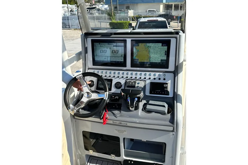 Slide: The Image of Helm of 2023 ShearWater 270 Carolina Flare boat with advanced navigation displays and controls. - 34