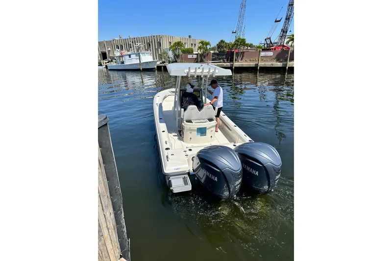 Slide: The Image of 2023 ShearWater 270 Carolina Flare boat with dual Yamaha engines docked in marina. - 35