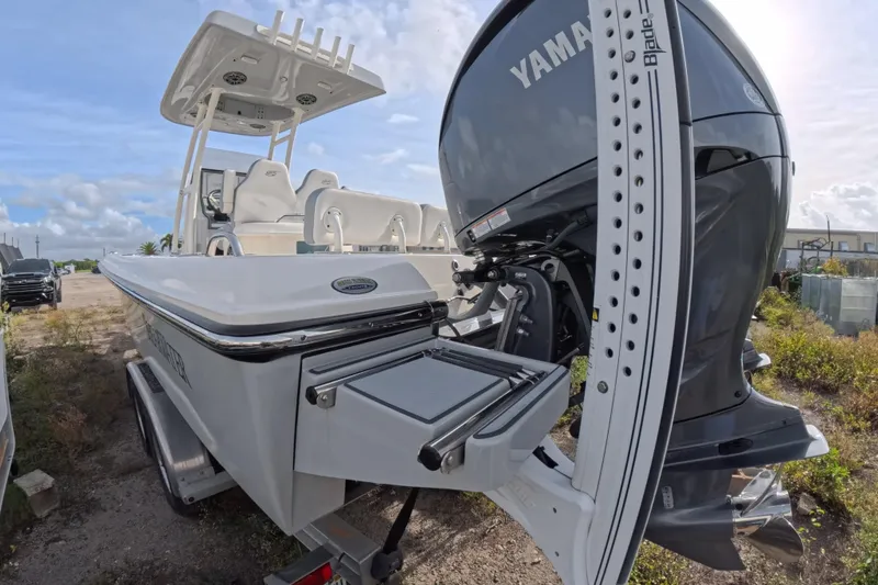 Slide: The Image of 2023 ShearWater 270 Carolina Flare boat with Yamaha engine, parked outdoors on a trailer. - 8