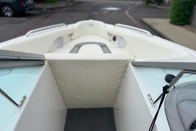 Slide: The Image of 2005 MasterCraft MariStar 230 VRS boat interior with white seating and sleek design. - 16