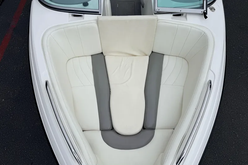 Slide: The Image of 2005 MasterCraft MariStar 230 VRS boat interior with white and gray cushioned seating. - 17