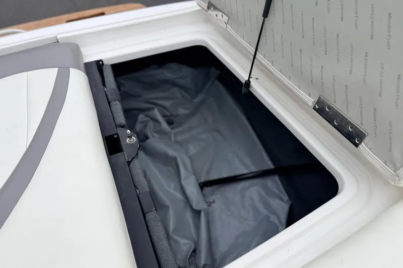 Slide: The Image of Open storage compartment of 2005 MasterCraft MariStar 230 VRS boat. - 23