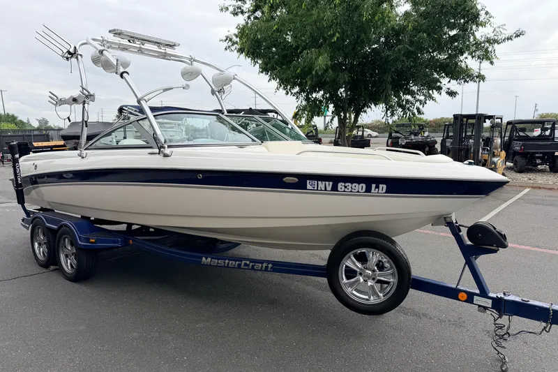 Slide: The Image of 2005 MasterCraft MariStar 230 VRS boat on trailer, parked outdoors. - 3