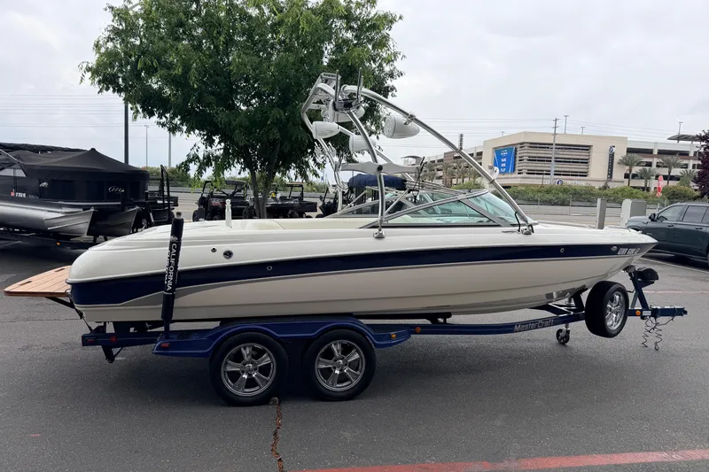 Slide: The Image of 2005 MasterCraft MariStar 230 VRS boat on trailer in parking lot. - 4
