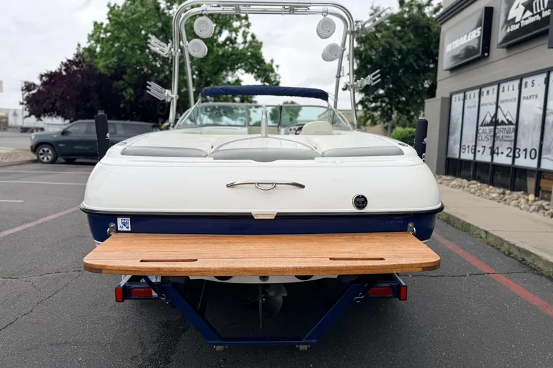 Slide: The Image of 2005 MasterCraft MariStar 230 VRS boat, rear view with swim platform, parked outdoors. - 6