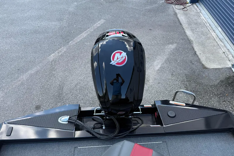 Slide: The Image of 2023 Ranger RT188P boat with a sleek black motor on a concrete surface. - 11