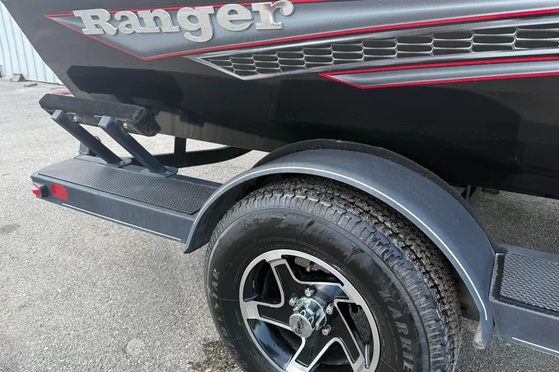 Slide: The Image of 2023 Ranger RT188P boat trailer with black tire and red accents. - 3