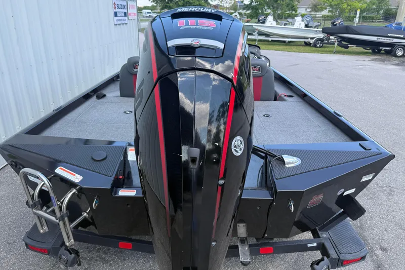 Slide: The Image of 2023 Ranger RT188P boat with Mercury 115 engine, parked outdoors. - 4
