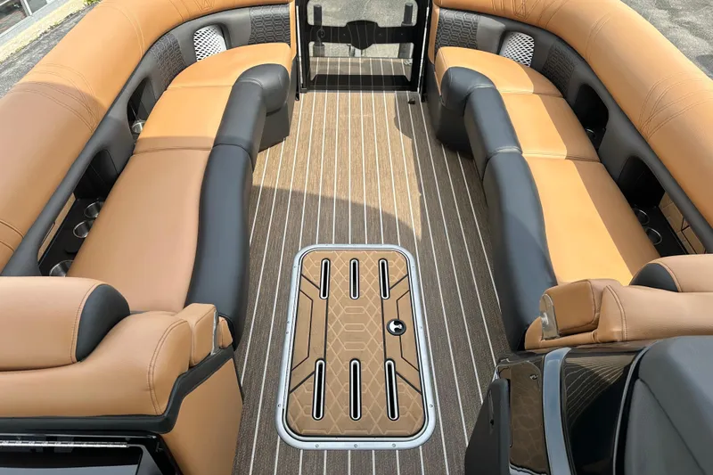 Slide: The Image of Luxurious interior of 2026 Premier 250 Intrigue RLO pontoon boat with tan seating. - 16