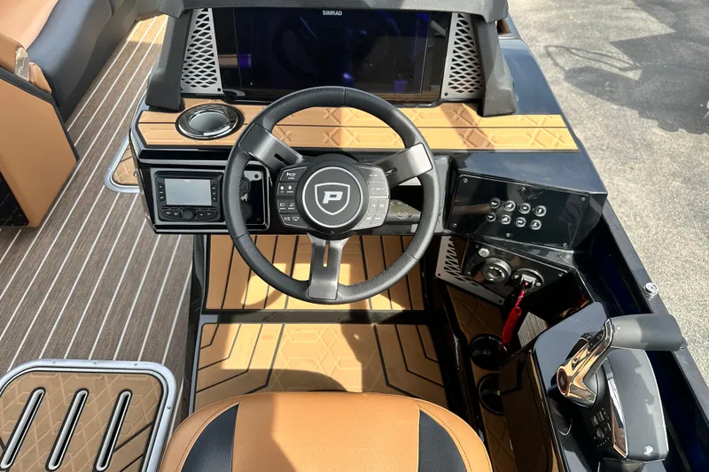 Slide: The Image of Interior view of 2026 Premier 250 Intrigue RLO boat, featuring modern steering and control panel. - 18
