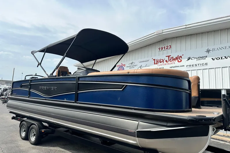 Slide: The Image of 2026 Premier 250 Intrigue RLO pontoon boat on trailer at dealership. - 3