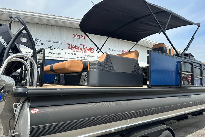 Slide: The Image of 2026 Premier 250 Intrigue RLO pontoon boat with canopy at dealership. - 4