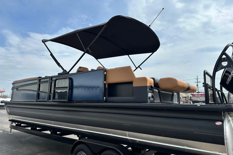 Slide: The Image of 2026 Premier 250 Intrigue RLO pontoon boat with canopy, parked on trailer. - 5
