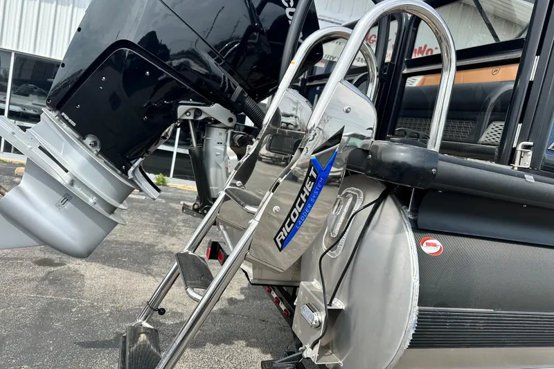Slide: The Image of Premier 250 Intrigue RLO 2026 boat with Ricochet ladder system and powerful outboard motor. - 6