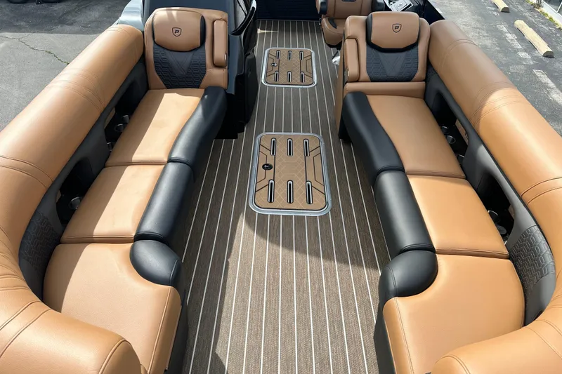 Slide: The Image of Luxurious interior of 2026 Premier 250 Intrigue RLO pontoon boat with tan and black seating. - 9
