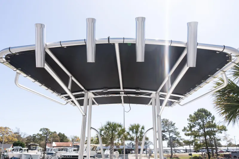 Slide: The Image of 2012 Sea Hunt Triton 188 boat with T-top and rod holders under sunny sky. - 11