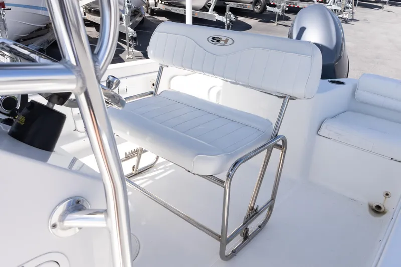 Slide: The Image of 2012 Sea Hunt Triton 188 boat interior with white seating and stainless steel frame. - 12