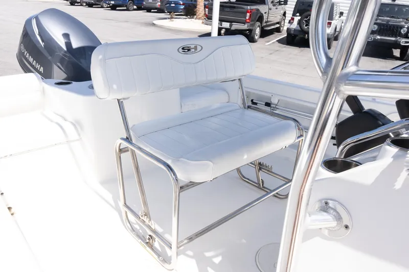 Slide: The Image of 2012 Sea Hunt Triton 188 boat interior with Yamaha engine and white seating. - 13
