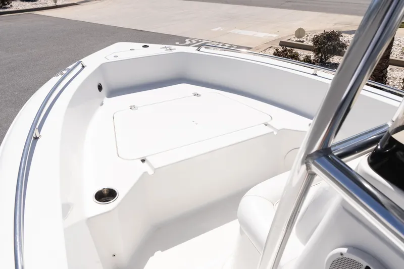 Slide: The Image of 2012 Sea Hunt Triton 188 boat interior with white seating and stainless steel railings. - 15