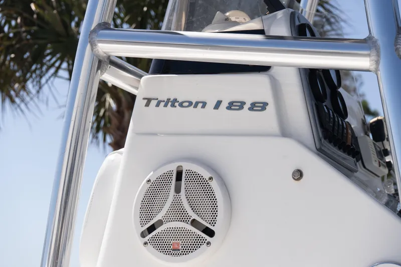 Slide: The Image of 2012 Sea Hunt Triton 188 boat console with speaker, palm tree background. - 17