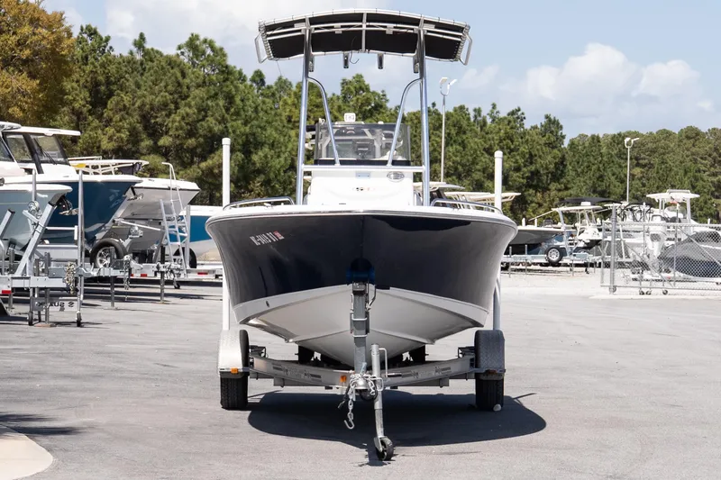 Slide: The Image of 2012 Sea Hunt Triton 188 boat on trailer, parked in a marina with other boats. - 3