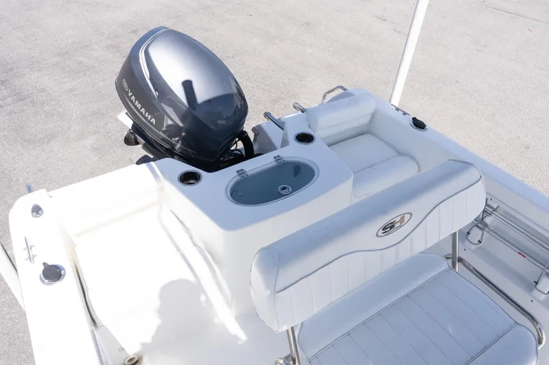 Slide: The Image of 2012 Sea Hunt Triton 188 boat with Yamaha outboard motor, featuring white seating and console. - 8