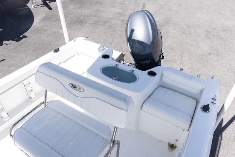 Slide: The Image of 2012 Sea Hunt Triton 188 boat interior with seating and outboard motor. - 9