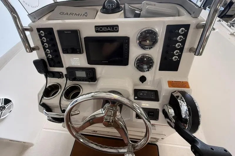 Slide: The Image of 2018 Robalo R180 Center Console dashboard with Garmin electronics and steering wheel. - 10