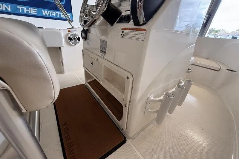 Slide: The Image of 2018 Robalo R180 Center Console interior with steering wheel and storage compartments. - 11