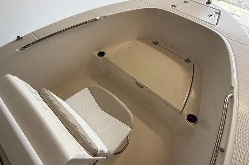 Slide: The Image of 2018 Robalo R180 Center Console boat interior with seating and storage. - 14