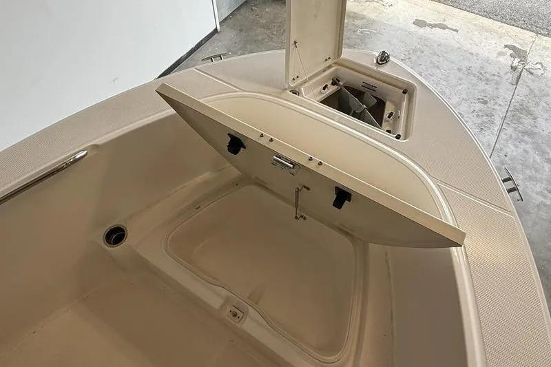 Slide: The Image of 2018 Robalo R180 Center Console boat storage compartments open. - 15