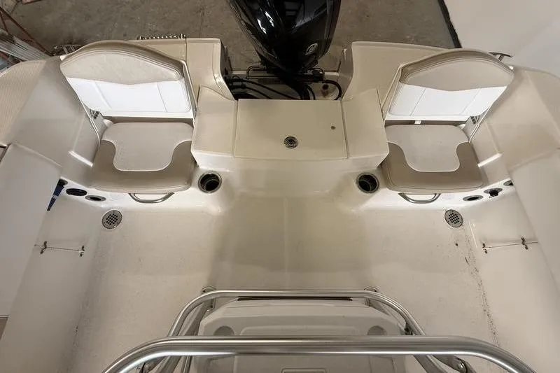 Slide: The Image of 2018 Robalo R180 Center Console boat interior with seating and motor view. - 5