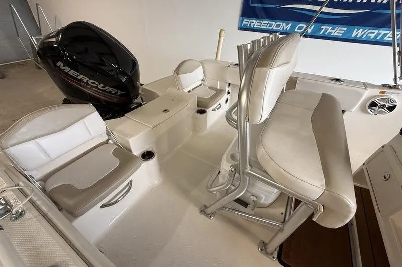 Slide: The Image of 2018 Robalo R180 Center Console boat interior with Mercury engine and seating arrangement. - 6