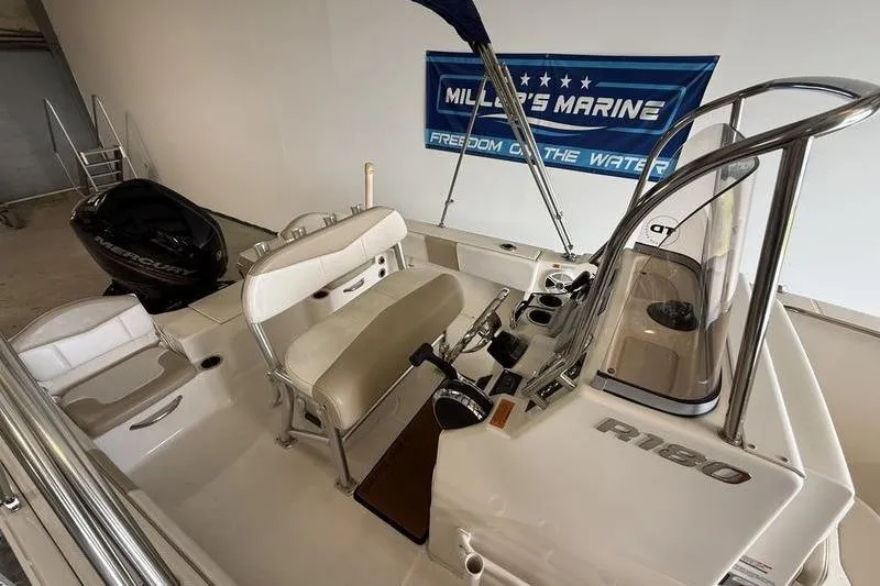 Slide: The Image of 2018 Robalo R180 Center Console boat interior with seating and controls. - 7