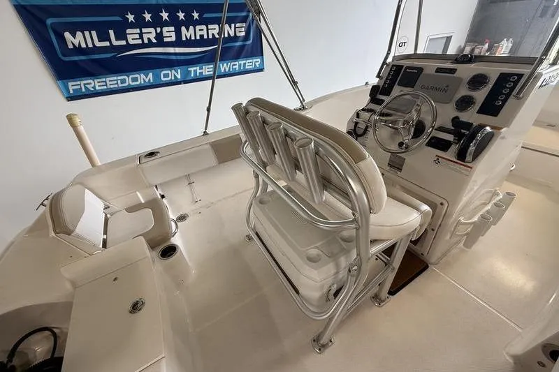 Slide: The Image of 2018 Robalo R180 Center Console boat interior with helm and seating. - 8