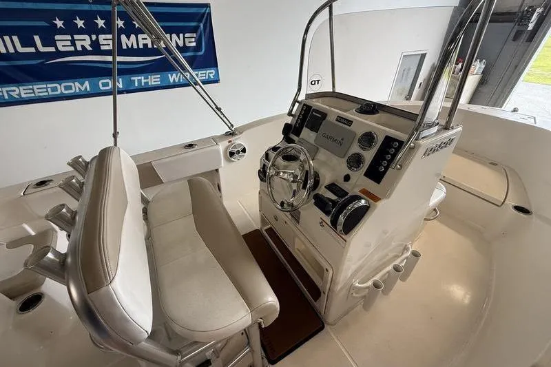 Slide: The Image of 2018 Robalo R180 Center Console boat interior with steering wheel and controls. - 9