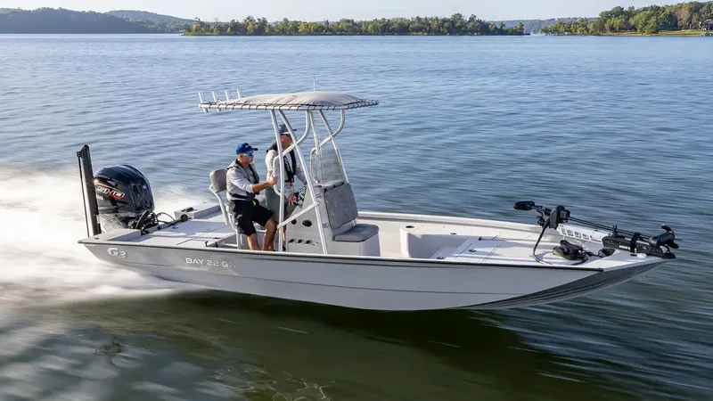 Slide: The Image of 2026 G3 Bay 22 GX boat cruising on a serene lake. - 23