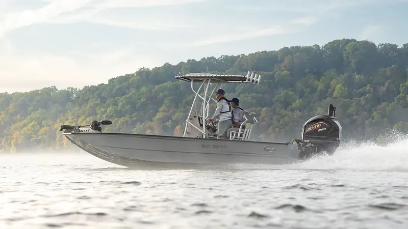 Slide: The Image of 2026 G3 Bay 22 GX boat cruising on a serene lake. - 25