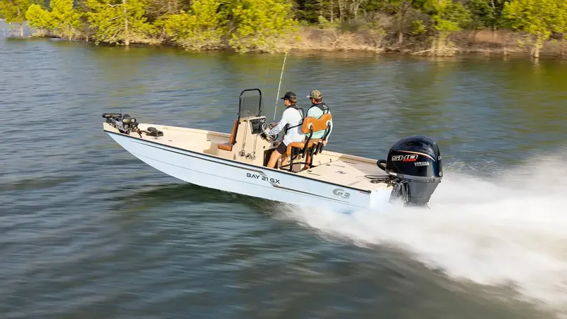 Slide: The Image of G3 Bay 21 GX 2026 boat cruising on a lake. - 23