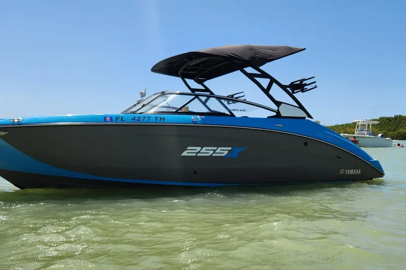 The Image of 2022 Yamaha Boats 255XD in water, sleek design, blue and black color scheme. - 0