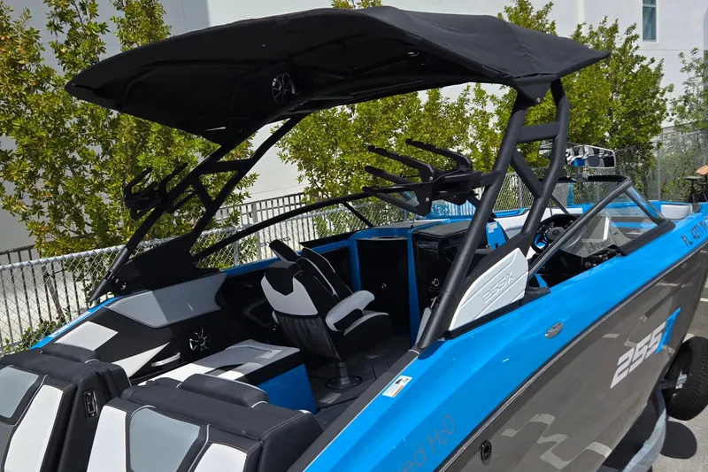 Slide: The Image of 2022 Yamaha Boats 255XD with sleek design and modern features, docked outdoors. - 2
