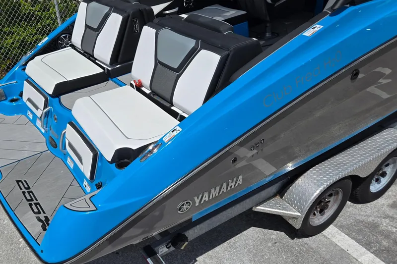 Slide: The Image of 2022 Yamaha Boats 255XD with sleek seating and vibrant blue exterior. - 20