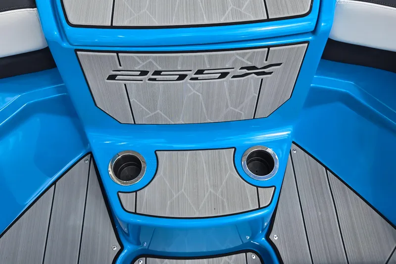 Slide: The Image of 2022 Yamaha Boats 255XD interior with blue accents and cup holders. - 33